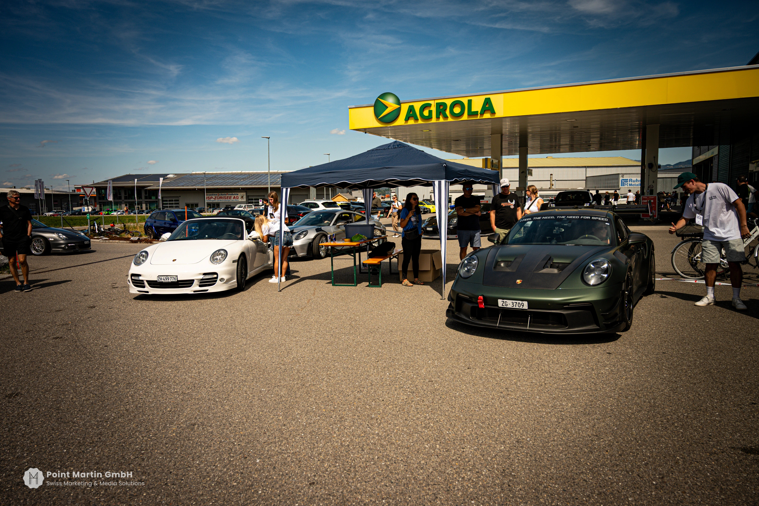 Porsches and visitors gathered outside the forecourt at German Car Meet 2026